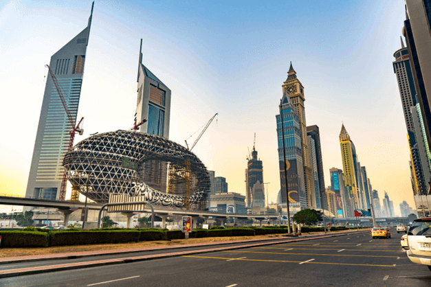 متحف المستقبل و أمامه عدة أبراج و ناطحات سحاب عالية و طريق للسيارات في السماء في امارة دبي الامارات العربية المتحدة